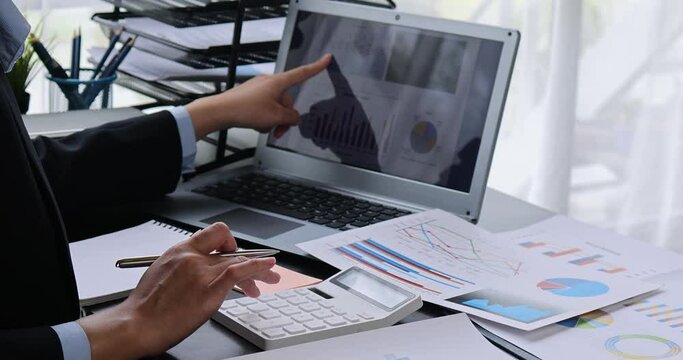 Businesswoman working at office with documents on his desk, doing planning analyzing the financial report, business plan investment, finance analysis concept	