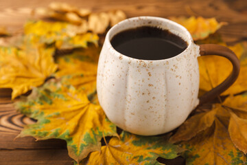 Autumn still life. Cocoa with marshmallows and maple leaves on a wooden table. Autumn season concept. Warming drink for relaxation, autumn weekend mood. Place for text. Place to copy. Flat lay