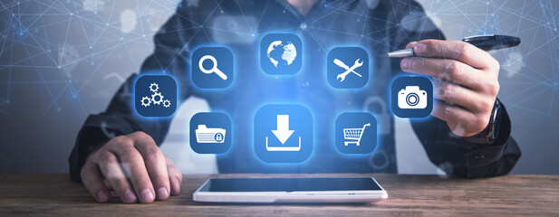 Man showing App icons with a download symbol. Development of applications. Social networks and Software