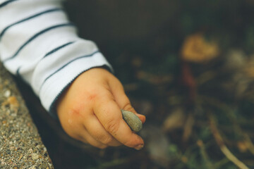 baby hand holding stone