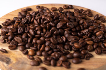 Coffee beans lying on a wooden board in close-up