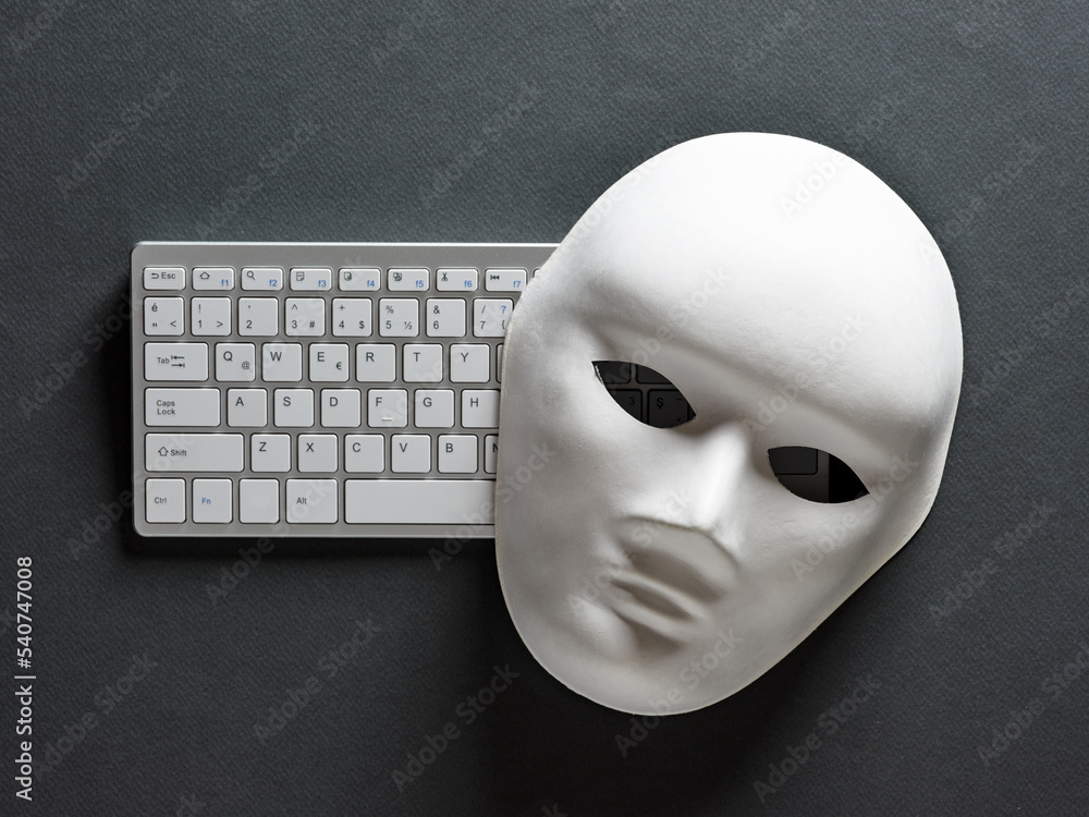 Poster white face mask and computer keyboard on black background. hacker, computer hacking, cybercrime, sca
