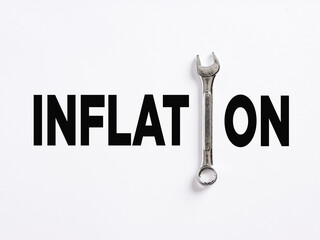 The word inflation written with a wrench. Fixing inflation, fight with inflation strategies concept.