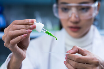 Scientists are dripping organic plant extracts into test tubes and plates in the laboratory, Researchers testing plant-based drugs.