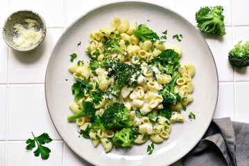 Pasta with broccoli and cream sauce. Top view with copy space.