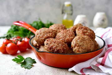 Homemade meat cutlets in a skillet pan.