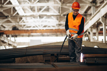 Man cutting steel at the factory