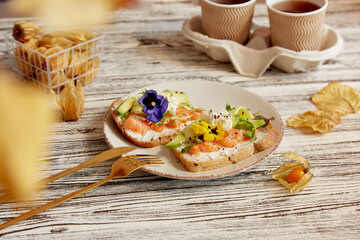Aesthetic breakfast, lunch time with appetizer with smoked salmon, avocado, arugula, cucumber and...