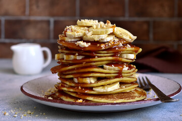 Hot pancakes with banana, nuts  and caramel sauce.