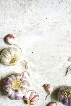 Culinary background with bulbs of garlic. Top view with copy space.