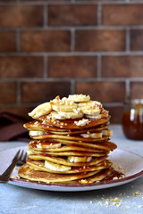 Hot pancakes with banana, nuts  and caramel sauce.