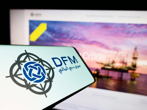 Stuttgart, Germany - 10-13-2022: Mobile phone with logo of stock exchange Dubai Financial Market (DFM) on screen in front of company website. Focus on center of phone display.