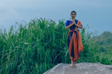 Yogini doing Asana in an ancient temple