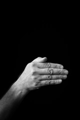 Hand demonstrating the Japanese sign language letter 'KU' or 'く' with copy space