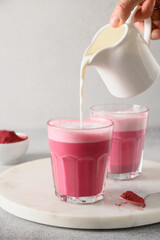 Beetroot latte on gray background. Cooking alternative caffeine free coffee.