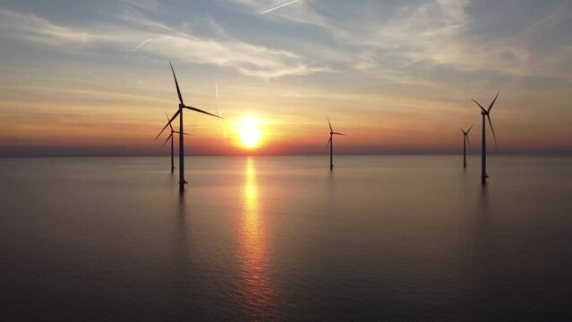 Aerial video of wind turbines in the sea during sunset in IJsselmeer near Urk in Flevoland, The Netherlands
