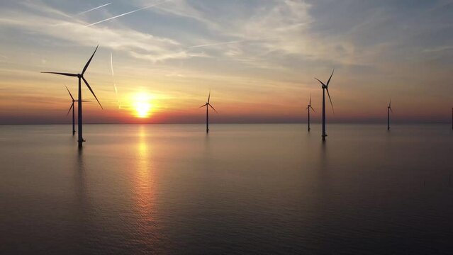Aerial video of wind turbines in the sea during sunset in IJsselmeer near Urk in Flevoland, The Netherlands