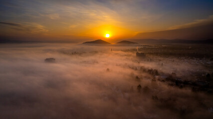 Fantastic view over cloud inversion sunrise mountains cityscape landscape