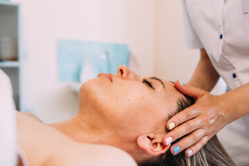 Obraz na płótnie Canvas Cosmetologist does facial massage for woman. Beauty skin care