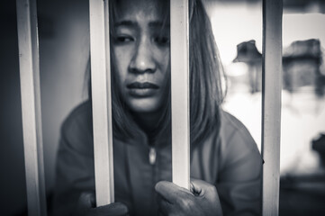 Portrait of women desperate to catch the iron prison,prisoner concept,thailand people,Hope to be...