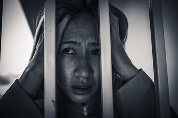 Portrait of women desperate to catch the iron prison,prisoner concept,thailand people,Hope to be...