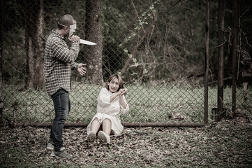 A serial killer scene is about to kill an Asian woman,concept thriller scene,Halloween festival