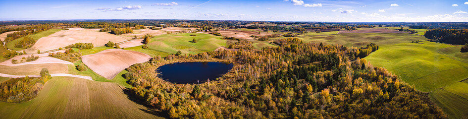 Aerial view of the fields,meadows,roads,lakes of the Suwalki land in Poland in sunny,autumn day.