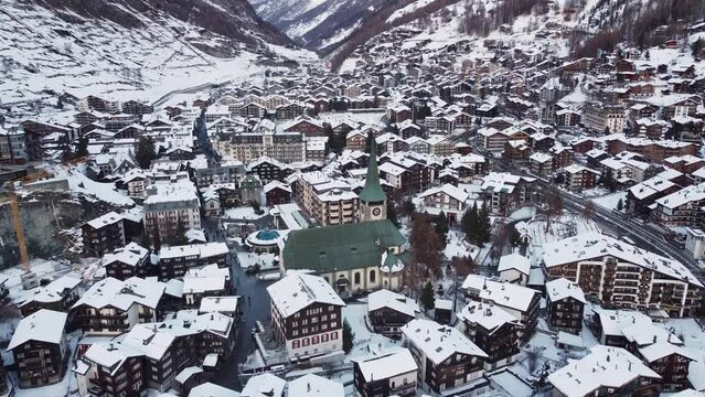 Zermatt, Switzerland: Aerial drone footage of the famous Zermatt traditional village in the Swiss alps in winter. 