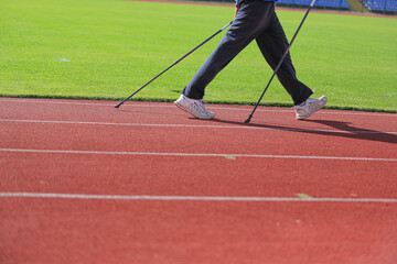 Athletes run and walk on the tracks in the stadium. the concept of sport and health.
