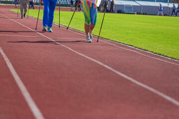 Athletes run and walk on the tracks in the stadium. the concept of sport and health.