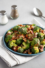 Homemade Broccoli Bacon Salad on a Plate on a gray background, side view.