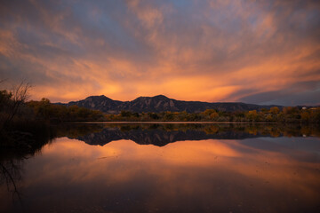 Sunrise over the flatirons with a lake reflection © Jacob Hall