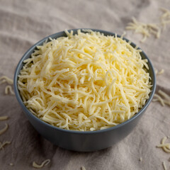 Shredded Mozzarella Cheese in a Bowl, side view.