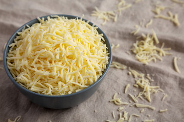 Shredded Mozzarella Cheese in a Bowl, side view.