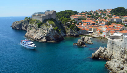 Dubrovnik  city wall ,Fort Lovrijenac and Wall small tourist trip boat on water