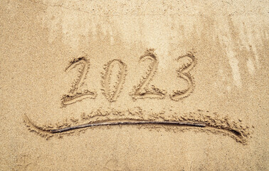 2023 handwritten in sand on a beautiful beach