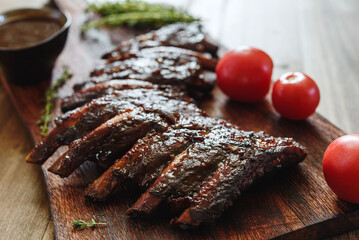 BBQ grilled pork ribs in Barbecue sauce on vintage wooden table background. Barbecue Pork Spare Ribs. Tasty snack to beer. American food concept. Selective focus - 540770673
