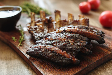 BBQ grilled pork ribs in Barbecue sauce on vintage wooden table background. Barbecue Pork Spare Ribs. Tasty snack to beer. American food concept. Selective focus - 540770675