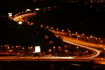 Fototapeta na wymiar Night-lit large intersection on the highway ring, Barrandovský most in Prague