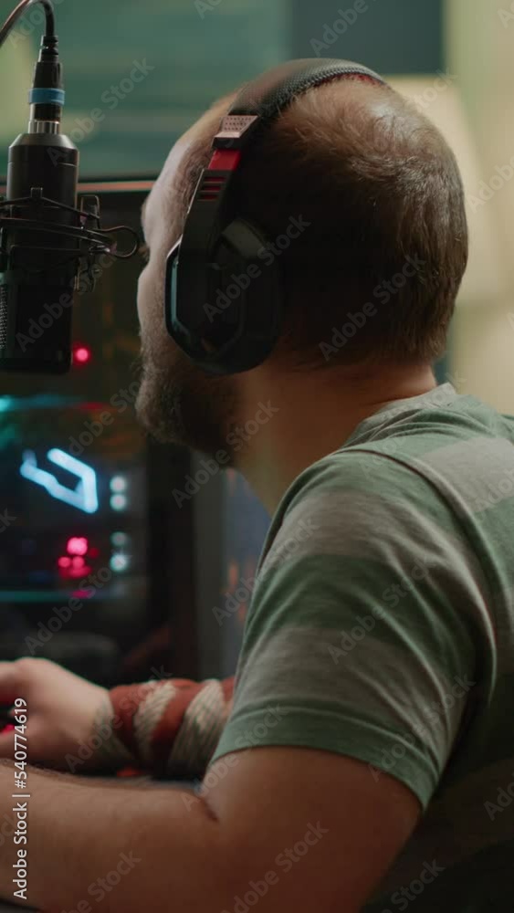Poster vertical video: nevous streamer losing videogame, game over for man cyber playing online space shoot