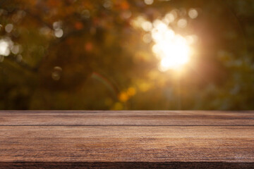 Naklejka na ściany i meble Wooden table on a natural blurred background