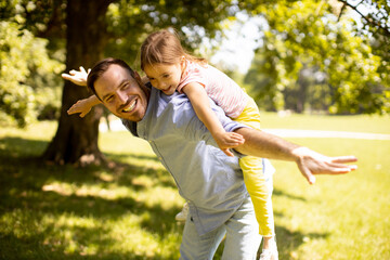 Fototapeta premium Father with daughter having fun at the park