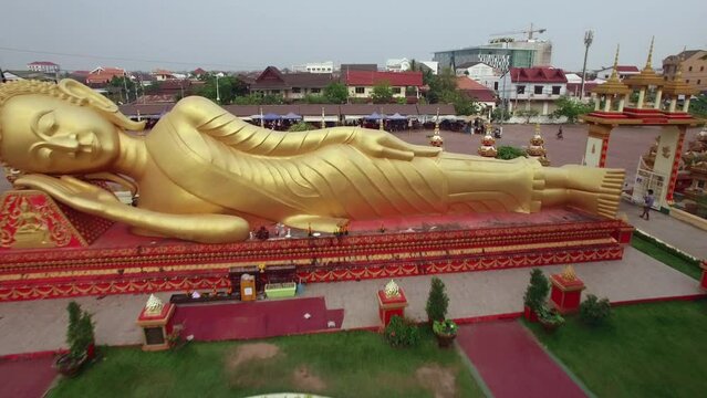 Aerial view of reclining buddha statue at the Wat Pha That Luang temple complex in Vientiane, the capital and largest city in Laos. 