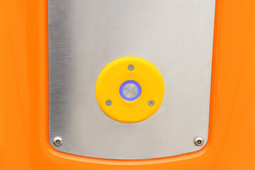 Close-up of the start and pause button on a gray and orange background. Close-up blank button. Start-up