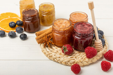 Jar of honey. Fruit honey with raspberries, blueberries, almonds and pistachios. Jams for health and beauty. Honey cream. Organic product of a vegetarian diet. Copy space.Copy space.