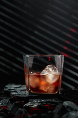 Whiskey with ice in dampened glass.