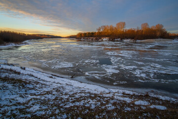 winter landscape with river and sun