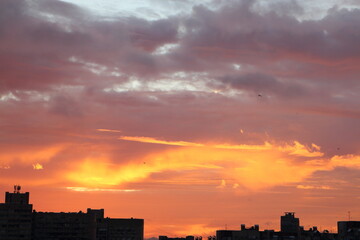 red clouds at sunset over the city block