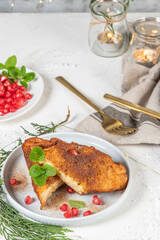 Traditional Christmas Rabanadas with lemon zest, pomegranate, pine nuts and cinnamon. Spanish Torrijas or french toasts close up on the countertop