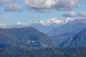 Mountains and snow peaks under beautiful clouds. The Caucasian ridge.